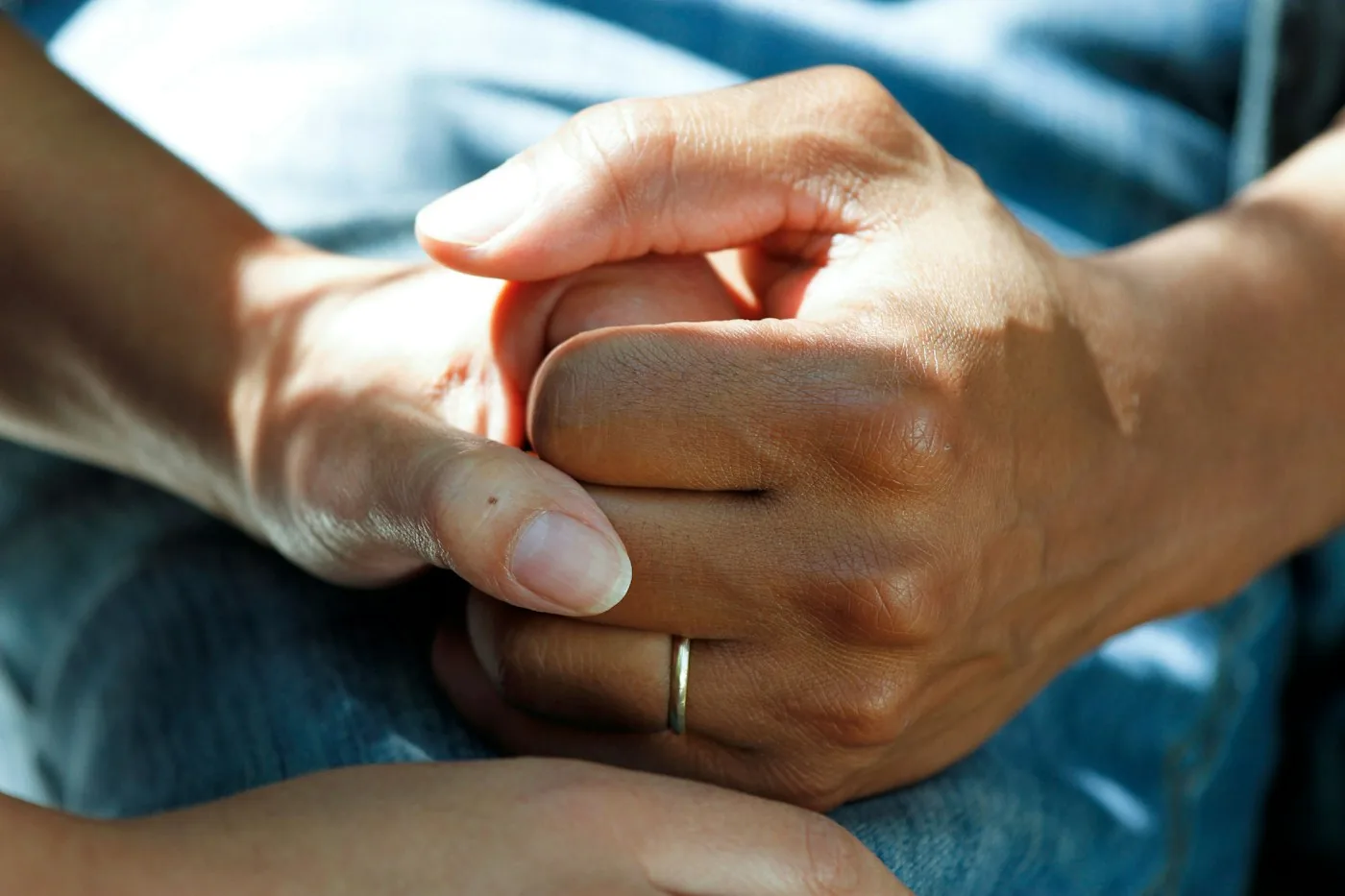 Two people holding hands in a moment of support