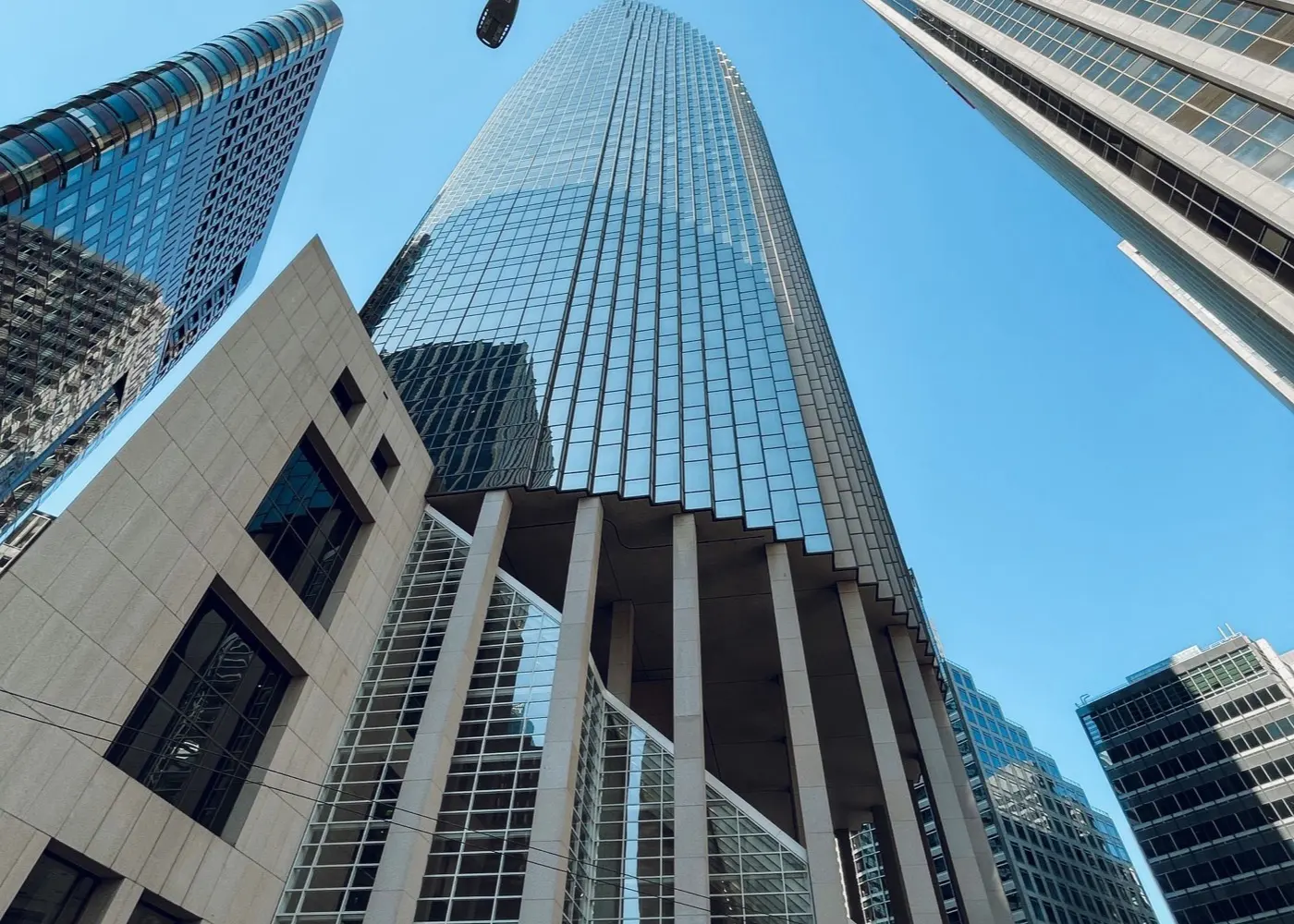 Glass towers rising over a financial district