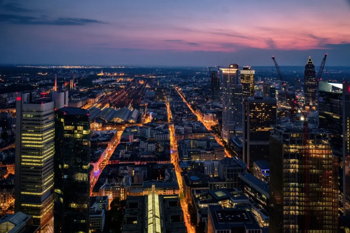A city skyline at dusk, lit up across many sectors